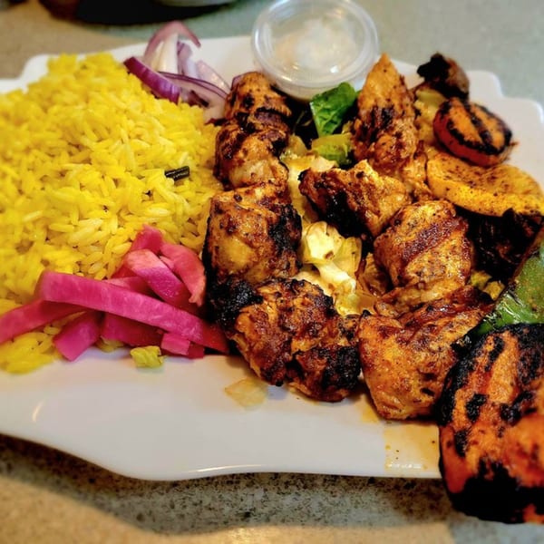 LaVie Mediterranean Grill's chicken shish tawook with yellow rice, pickled turnips, and grilled vegetables.