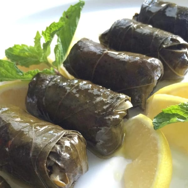 LaVie Mediterranean Grill's dolmades, grape leaves stuffed with rice, garnished with lemon wedges and mint.